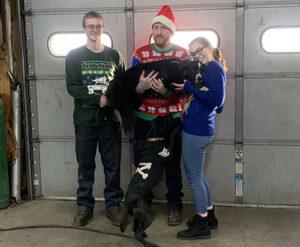 Xmas group pic with a black dog in the repair bay